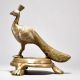 Brass Peacock Figurine on Table